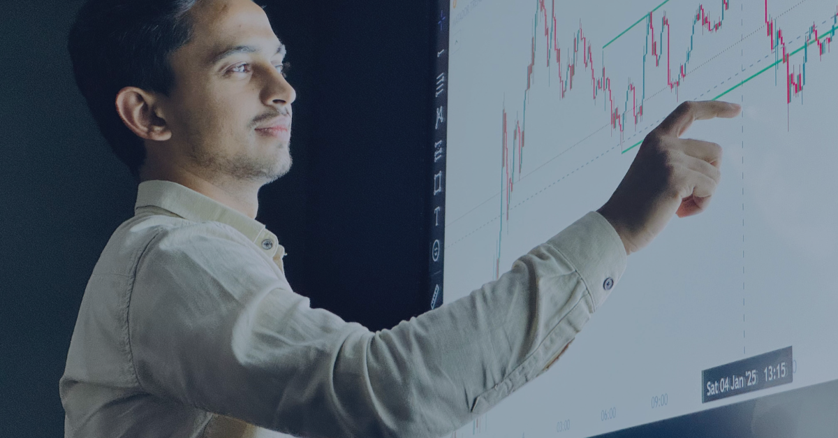 Person using interactive screen and pointing at market graph